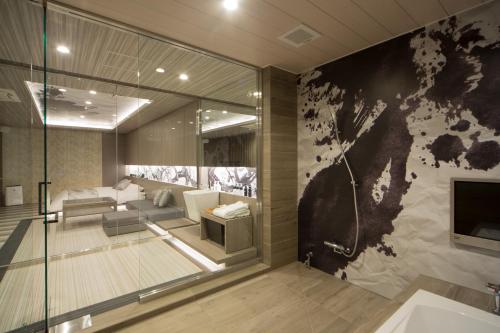 a living room with a large glass wall at WA HOTEL TIMELESS RESORT - Adult Only in Wakayama