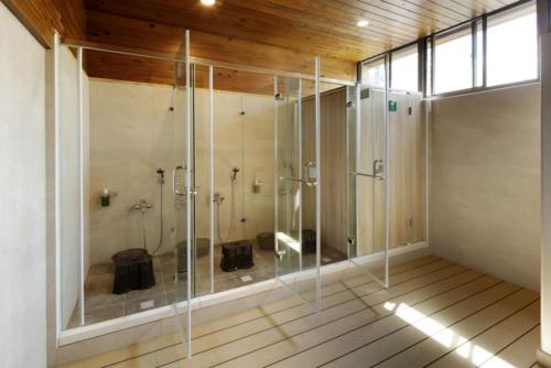 a bathroom with a shower with glass walls at Chilan Hotel in Datong