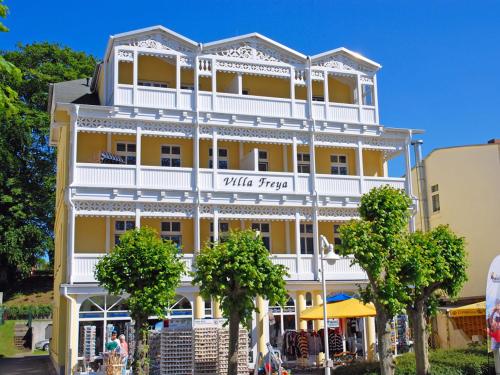 a large yellow building with white trim at Villa Freya - Apt. 07 in Ostseebad Sellin