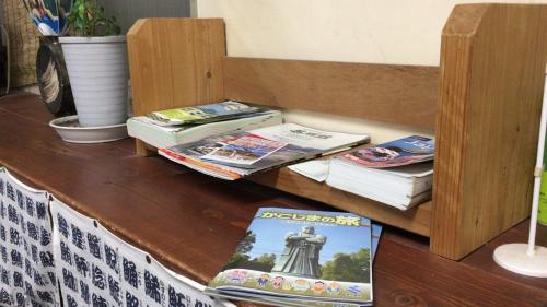 a shelf with books and magazines on a table at Kagoshima Little Asia in Kagoshima
