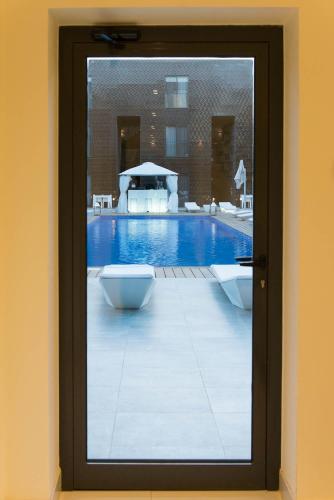 a framed picture of a pool with a table and chairs at Nacala Plaza Business Design Hotel in Cidade de Nacala