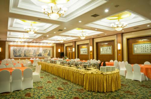 
a large room filled with tables and chairs at Xijiao Hotel Beijing in Beijing
