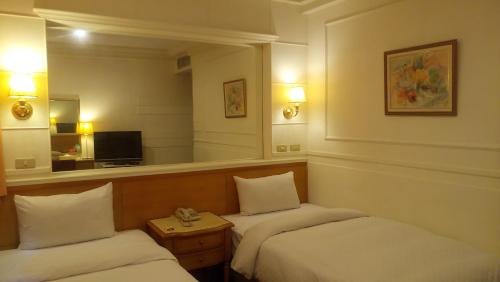Postel nebo postele na pokoji v ubytování 苓雅大飯店 Lingyea Hotel