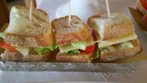 a group of sandwiches sitting on a glass plate at Il Rifugio del Poeta in San Biagio di Callalta
