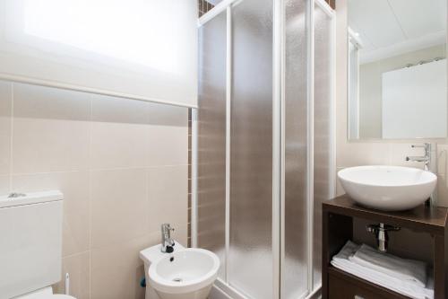 a bathroom with a sink and a toilet and a shower at City Center Atico 360 in Valencia