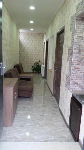 an empty living room with a couch and a door at Apartments on Akhalubani St 2 in Tbilisi City