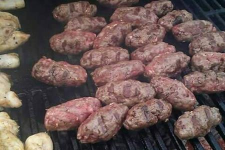 a group of meatballs and vegetables on a grill at KUĆA ŠKRABIĆ in Baška Voda
