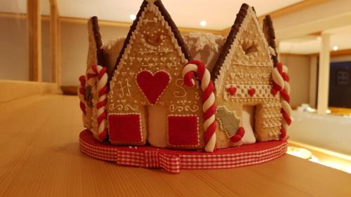 a gingerbread house cake sitting on top of a table at Hôtel Splendide in Crans-Montana