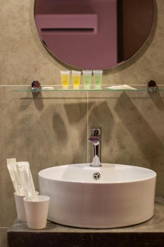 a white sink in a bathroom with a mirror at Hotel Twenty 8B in Kuala Lumpur