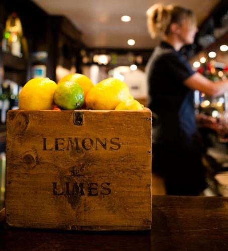 a sign that says lemons and limes in a store at The Horseshoe Country Inn in Pickering
