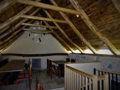 a room with wooden ceilings and a table and chairs at Domaine des Marequiers chambre Alchemille in Saint-Germain-du-Teil