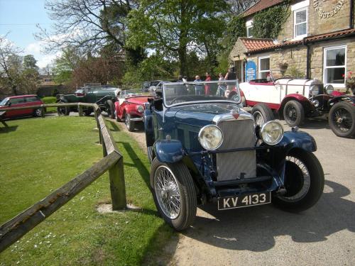 an old blue car parked on the side of a road at The Horseshoe Country Inn in Pickering