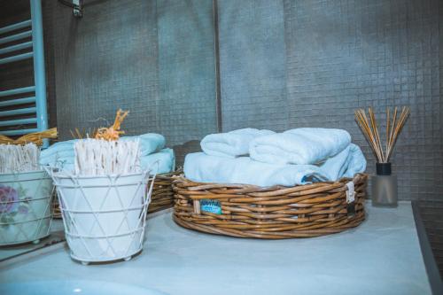 two baskets of towels are sitting on a table at Apartment Mountain Orchid in Gudauri
