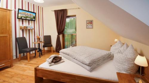 a bedroom with a bed and a table and chairs at Gästezimmer Hans-Norbert Mack in Hallgarten