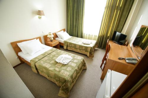 Кровать или кровати в номере Гостиница Виктория Палас