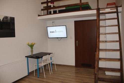 a dining room with a table and a bunk bed at Pokoje Babina in Kalisz