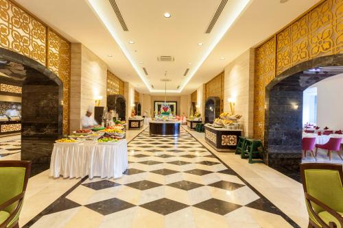 a lobby of a hotel with tables and chairs at Melas Lara Hotel in Lara
