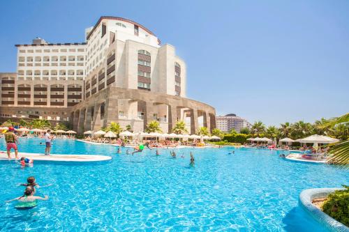 a large swimming pool in front of a building at Melas Lara Hotel in Lara