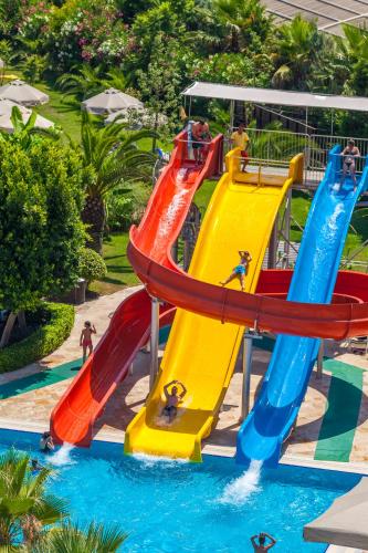 a group of people on a water slide at a water park at Melas Lara Hotel in Lara