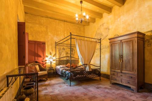 a bedroom with a bed and a dresser in it at El Asiento Del Azar in Banyeres del Penedes