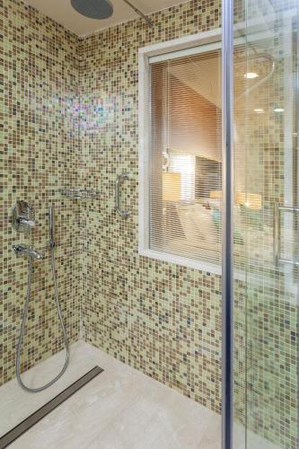 a bathroom with a shower with a glass door at Melas Lara Hotel in Lara
