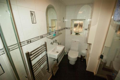a small bathroom with a sink and a toilet at No. 2 Watch House in Dawlish