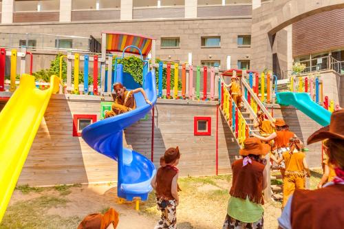 a group of children playing on a playground at Melas Lara Hotel in Lara
