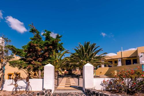 a view of a resort with palm trees and stairs at Caldera View Resort - Adults Only in Akrotiri