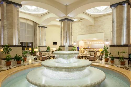 a large lobby with a large fountain in the middle at Melas Lara Hotel in Lara