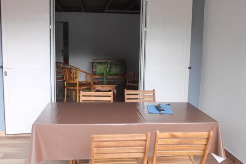 a table with two chairs and a table with a napkin on it at les cases prés du lac in Cilaos