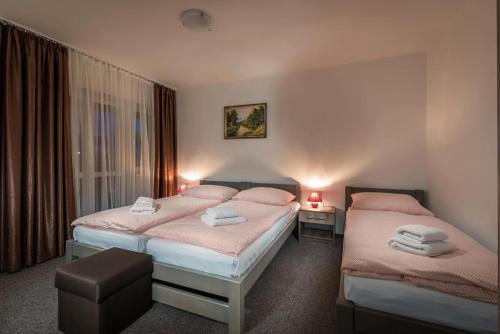Кровать или кровати в номере Penzion Panorama