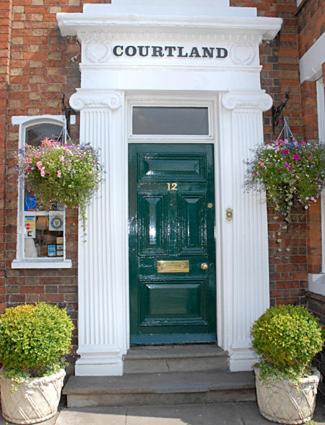 a green door of a building with a sign for a courthouse at Courtland in Stratford-upon-Avon