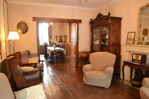 a living room with chairs and a dining room at Demeure VERTEUILLAISE in Verteuil-sur-Charente