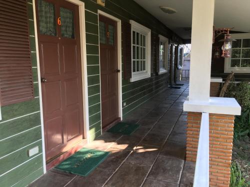 a front porch of a house with a red door at The Green land (Khok Kruat) in Nakhon Ratchasima