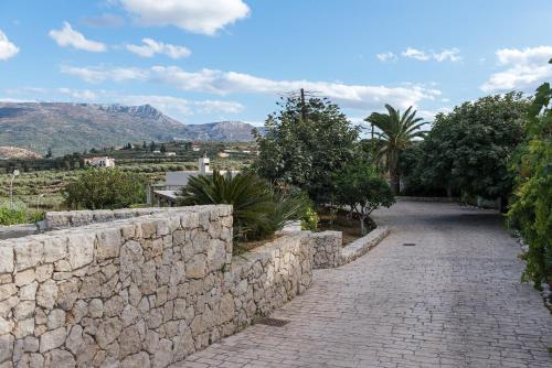 a stone path with a stone retaining wall at Panorama Villa Private Pool, BBQ, Parking in Sitia