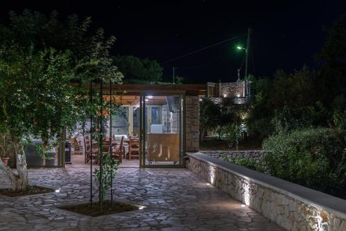 a stone walkway leading to a house at night at Panorama Villa Private Pool, BBQ, Parking in Sitia