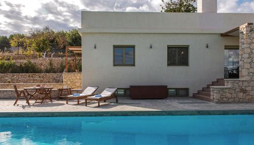 a house with a pool and a table and chairs at Panorama Villa Private Pool, BBQ, Parking in Sitia