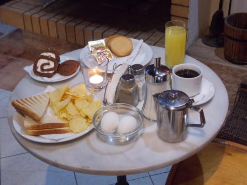 a table topped with plates of food and drinks at Sparta Team Hotel in Athens