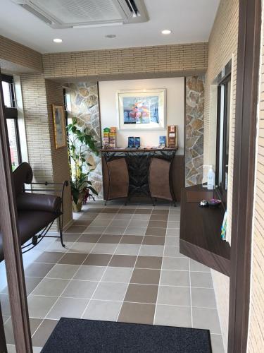 a lobby with a fireplace and a waiting room at Seaside Condominium Rana Chatan in Chatan
