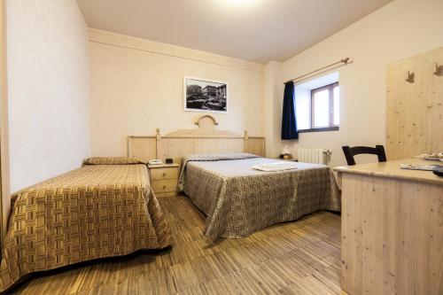 Postel nebo postele na pokoji v ubytování Rifugio Sapienza