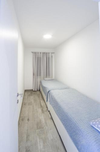 a bedroom with a bed and a window at Mare in Rogoznica