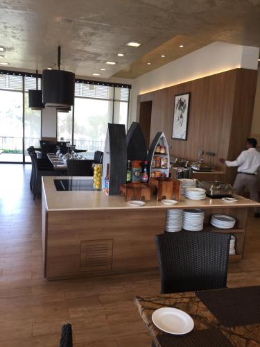 a kitchen with a counter with plates on it at Beautiful Apartments at Tarudhan Valley Golf Resort, Manesar in Gurgaon