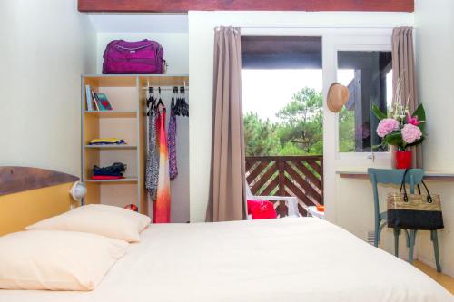 a bedroom with a bed and a window at VTF La Forestière in Lacanau-Océan