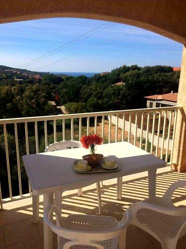 a white table and chairs on a balcony at Résidence Assuliu in Propriano