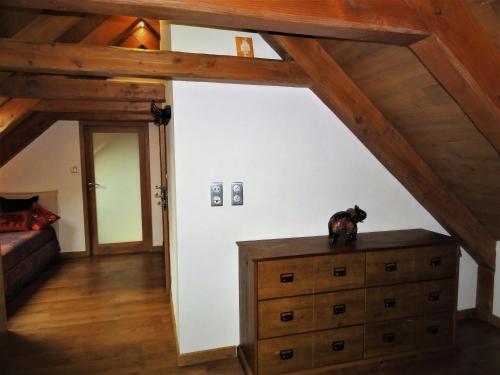 a room with a dresser with a dog sitting on top of it at Domaine des Marequiers le Gite Aigremoine in Saint-Germain-du-Teil