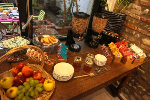 a table topped with baskets of fruit and other food at Hôtel La Chartreuse in Toulouse