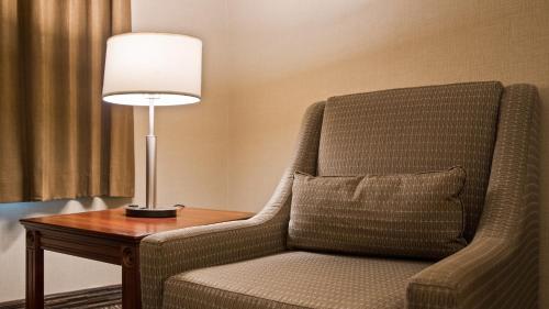 a lamp sitting on a table next to a chair at Best Western Brantford Hotel and Conference Centre in Brantford