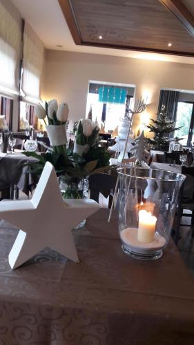 a table with a candle and a white star on it at Hotel Restaurant Beau Séjour in Morsbronn-les-Bains