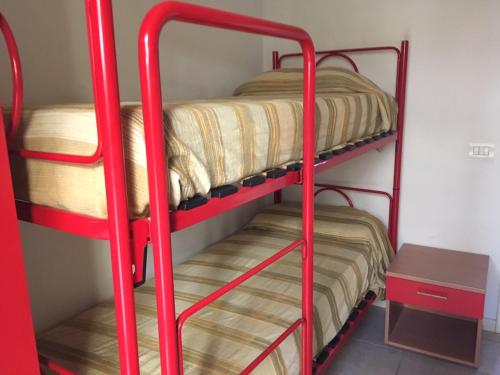 two bunk beds in a room with a table at Gugliormella in Sirolo