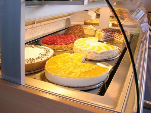 a display case with many different types of cakes at Cafe Rundblick in Baiersbronn